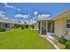 Expansive backyard featuring well-manicured lawn and access to the screened-in patio at 1210 Eastloch Ct, Sun City Center, FL 33573
