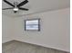 Bedroom with a window and ceiling fan at 1210 Eastloch Ct, Sun City Center, FL 33573