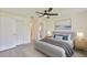 Serene bedroom with neutral tones, a comfortable queen-sized bed, closet, and modern ceiling fan for enhanced airflow at 1210 Eastloch Ct, Sun City Center, FL 33573