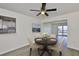 Cozy dining area with a modern chandelier, a dark round table set for four, and views into the bright living spaces at 1210 Eastloch Ct, Sun City Center, FL 33573