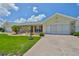 Charming home featuring a well-manicured lawn and a lovely stone accent, complete with an attached two-car garage at 1210 Eastloch Ct, Sun City Center, FL 33573