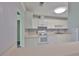 Bright kitchen boasts white appliances, cabinets, and countertops at 1210 Eastloch Ct, Sun City Center, FL 33573