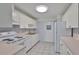 Functional kitchen with white appliances, ample cabinet space, and a bright window to enhance the cooking experience at 1210 Eastloch Ct, Sun City Center, FL 33573