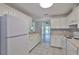 Classic white kitchen with view to the living area at 1210 Eastloch Ct, Sun City Center, FL 33573