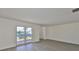 Bright living room featuring new flooring and sliding glass doors to the outside at 1210 Eastloch Ct, Sun City Center, FL 33573