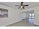 Open living room with updated floors, and view to kitchen and front yard at 1210 Eastloch Ct, Sun City Center, FL 33573