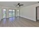 Spacious living room with neutral tones, hardwood floors, and large windows that offer plenty of natural light at 1210 Eastloch Ct, Sun City Center, FL 33573