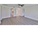 Open living room with wood-look floors, neutral walls and open kitchen at 1210 Eastloch Ct, Sun City Center, FL 33573