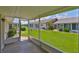 Screened patio with tile flooring overlooks the well-manicured lawn at 1210 Eastloch Ct, Sun City Center, FL 33573
