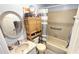 Clean bathroom features a vanity, toilet, storage shelves, and a shower/tub with a curtain at 13 Windrush Bay Dr, Tarpon Springs, FL 34689