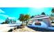 Welcoming beach entrance showcasing a well-maintained facade, clear blue skies, and sandy surroundings at 13 Windrush Bay Dr, Tarpon Springs, FL 34689