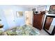 Angle view of bedroom with floral-patterned bed, closet, and artwork, offering a glimpse into another room at 13 Windrush Bay Dr, Tarpon Springs, FL 34689