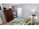 View of a bedroom displaying a wardrobe and mirror, a floral-patterned bed, and a sunlit window at 13 Windrush Bay Dr, Tarpon Springs, FL 34689