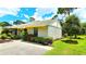 Charming home exterior displaying a well-manicured lawn, neat shrubbery, and a freshly paved driveway at 13 Windrush Bay Dr, Tarpon Springs, FL 34689