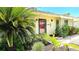 Attractive home with lush landscaping, featuring a red front door and inviting curb appeal at 13 Windrush Bay Dr, Tarpon Springs, FL 34689