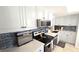 Modern kitchen featuring white cabinets, stainless steel appliances, and elegant countertops at 13 Windrush Bay Dr, Tarpon Springs, FL 34689