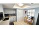 Bright kitchen featuring grey cabinets, tile backsplash, and a cozy breakfast nook with bar stools at 13 Windrush Bay Dr, Tarpon Springs, FL 34689