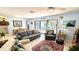 Spacious living room showcasing stylish decor, tile flooring, and access to the patio at 13 Windrush Bay Dr, Tarpon Springs, FL 34689