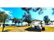 Scenic park featuring shaded picnic areas, trees, waterfront, and clear blue skies at 13 Windrush Bay Dr, Tarpon Springs, FL 34689