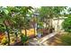 Enclosed patio with outdoor seating, lush foliage, and a pink bicycle, creating a cozy, inviting space at 13 Windrush Bay Dr, Tarpon Springs, FL 34689