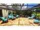 Relaxing outdoor patio featuring decorative lights, comfortable seating and garden views at 13 Windrush Bay Dr, Tarpon Springs, FL 34689