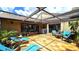 Enclosed patio showcases cozy seating, decorative lights, and access to the home's interior at 13 Windrush Bay Dr, Tarpon Springs, FL 34689