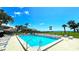 Inviting swimming pool with lounge chairs, tiki umbrellas, and well-maintained surroundings at 13 Windrush Bay Dr, Tarpon Springs, FL 34689