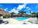 Community pool with tiki umbrellas and lounge chairs at 13 Windrush Bay Dr, Tarpon Springs, FL 34689