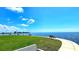 Peaceful view of the open water and green space from the community's park area at 13 Windrush Bay Dr, Tarpon Springs, FL 34689