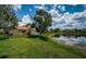 House backyard view of a pond on a sunny day at 1303 Forestedge Blvd, Oldsmar, FL 34677