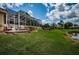 Enclosed patio with lawn, landscaping and pond view in a beautiful backyard at 1303 Forestedge Blvd, Oldsmar, FL 34677