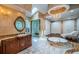 Spacious bathroom features a glass shower, soaking tub, marble floors, and a vanity at 1303 Forestedge Blvd, Oldsmar, FL 34677