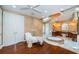 Luxurious bathroom with a soaking tub, vanity area, and hardwood floors at 1303 Forestedge Blvd, Oldsmar, FL 34677
