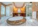 Elegant bathroom with a marble floor, soaking tub, dual vanities, and a glass shower at 1303 Forestedge Blvd, Oldsmar, FL 34677