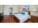 Primary bedroom features hardwood floors, a king-size bed, and a sitting area at 1303 Forestedge Blvd, Oldsmar, FL 34677