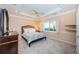 Inviting bedroom with a tray ceiling, recessed lighting, ceiling fan, and large window at 1303 Forestedge Blvd, Oldsmar, FL 34677