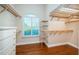 Spacious walk-in closet with custom wooden shelving and drawers for ample storage at 1303 Forestedge Blvd, Oldsmar, FL 34677