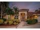 Charming home with mature landscaping, brick accents, and a grand entrance showcasing curb appeal and elegant design at 1303 Forestedge Blvd, Oldsmar, FL 34677