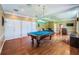 Entertaining game room complete with a pool table, recessed lighting, and hardwood flooring at 1303 Forestedge Blvd, Oldsmar, FL 34677