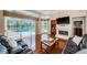 Bright living room with fireplace, hardwood floors, and a view of the pool at 1303 Forestedge Blvd, Oldsmar, FL 34677