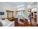 Spacious living room with hardwood floors, high ceilings, and a view of the pool area for a relaxing atmosphere at 1303 Forestedge Blvd, Oldsmar, FL 34677