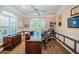 Home office featuring wood floors, built-in shelves, large window with natural light, and ample workspace at 1303 Forestedge Blvd, Oldsmar, FL 34677