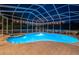 Screened-in pool with attached hot tub and string lights at 1303 Forestedge Blvd, Oldsmar, FL 34677