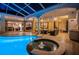 Enjoy the poolside view of the home, featuring a spa, outdoor furniture, and easy access from multiple rooms at 1303 Forestedge Blvd, Oldsmar, FL 34677