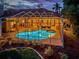A stunning outdoor pool and spa area enclosed in a screen with lovely landscaping at 1303 Forestedge Blvd, Oldsmar, FL 34677