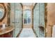 Walk in glass shower with marble tile and bench at 1303 Forestedge Blvd, Oldsmar, FL 34677