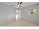 Neutral bedroom with tile flooring, ceiling fan, and natural light from window at 1309 11Th W Ave, Palmetto, FL 34221