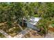 Aerial view of a well-maintained home with a metal roof, showcasing its curb appeal and landscaping at 1309 11Th W Ave, Palmetto, FL 34221