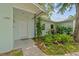 Inviting entrance featuring lush landscaping, a well-kept lawn, and a covered porch with support beam at 1309 11Th W Ave, Palmetto, FL 34221