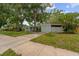 Charming single-story home with a well-maintained lawn and mature trees providing shade at 1309 11Th W Ave, Palmetto, FL 34221